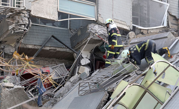 ▶ 구조대가 무너진 건물에서 생존자를 수색하고 있다.(사진 : AP)