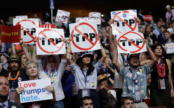 샌더스 지지자들이 전당 대회장에서 TPP(환태평양경제동반자 협정)를 반대한다는 피켓을 들고 있다.(사진=AP)