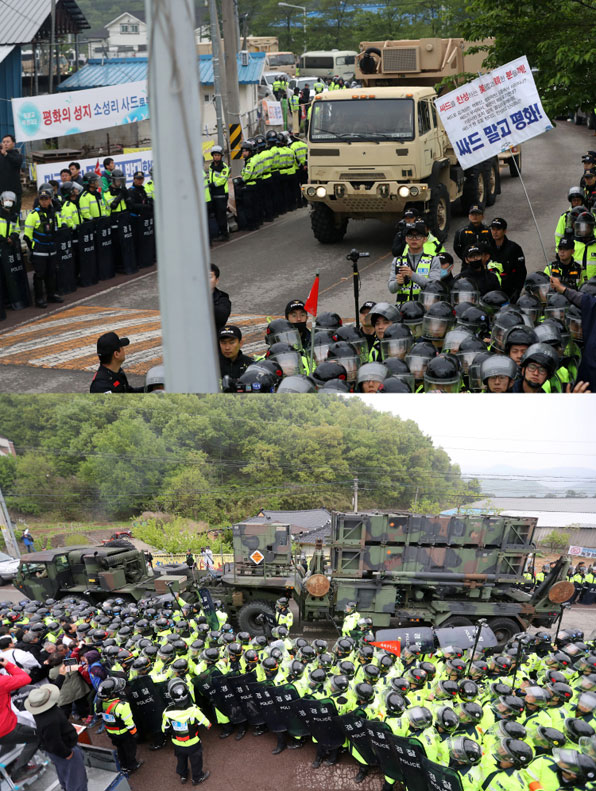 26일 오전 경북 성주군 성주골프장으로 사드(THAAD·고고도미사일방어체계) 관련 장비를 실은 트레일러가 들어가고 있는 가운데, 경찰이 주민들의 진입 방해를 막기 위해 도로를 애워싸고 있다.