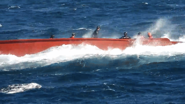 제주 마라도 남서쪽 해상에서 전복된 어선의 실종 선원들을 찾기 위해 해경 구조대원들이 사고 선박 위로 올라타 안전 작업을 하고 있다.(제공:제주지방해양경찰청)