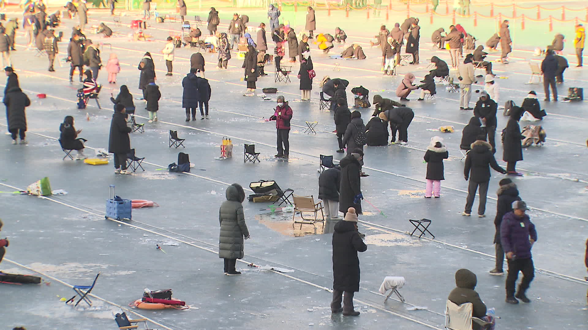 산천어 축제장에서 관광객들이 얼음 낚시를 즐기고 있다.
