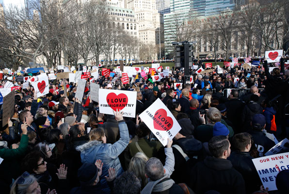 미국 시민들이 뉴욕 시 맨해튼의 배터리파크에서 ‘이민자를 사랑합니다.’ 손 푯말을 들고 시위를 벌이고 있다. (사진=AP)