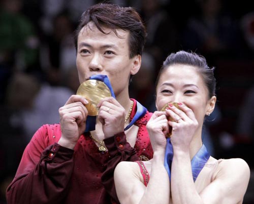 16일(한국시각) 밴쿠버 퍼시픽 콜리세움에서 열린 페어 프리 피겨 스케이팅 경기에서 우승을 차지한 중국의 선 쉐와 자오 홍보가 시상대에 올라 금메달에 입맞춤을 하고 있다.
