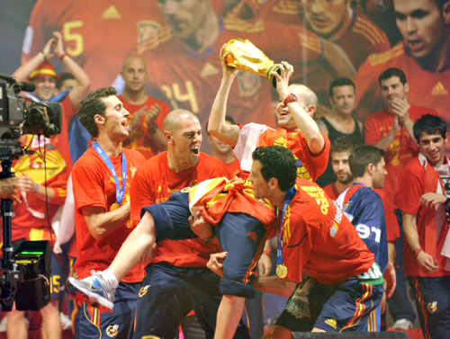 12일(현지시간) 2010 남아프리카공화국 월드컵 결승전에서 네덜란드에 1대 0으로 이겨 사상 첫 월드컵 우승하고 돌아온 스페인 축구 대표팀의 알바로 아르벨로아(왼쪽), 빅토르 발데스(왼쪽에서 두번째), 세르히오 부스케츠(오른쪽)가 축하연에서 팀 동료 이니에스타를 헹가레 치고 있다.
