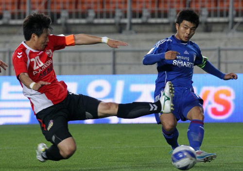 18일 수원월드컵경기장에서 열린 FA(축구협회)컵 32강전 포천시민축구단과 수원 삼성의 경기에서 수원 최성국(오른쪽)이 포천 골키퍼 오태환의 수비를 피해 센터링하고 있다.