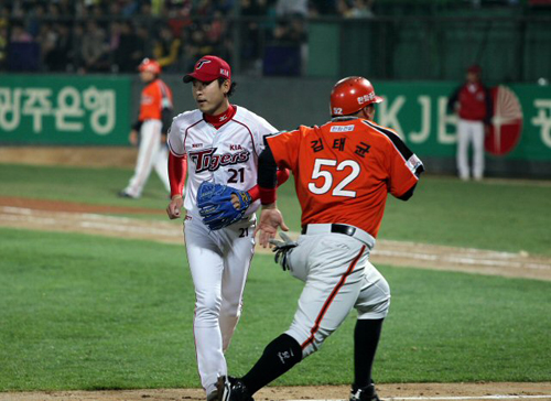 24일 광주 무등야구장에서 열린 2012 프로야구 기아 타이거즈-한화 이글스 경기, 기아 선발 투수 윤석민이 홈으로 쇄도하는 한화 김태균과 마주치며 안타까운 표정을 짓고 있다.