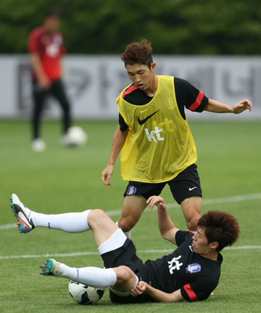 축구국가대표팀 김보경(앞쪽)이 13일 오후 경기도 파주 국가대표 트레이닝센터(NFC)에서 열린 공식훈련에서 이승기와 볼경합을 벌이다 넘어지고 있다. 대표팀은 오는 18일 이란과의 2014브라질월드컵 최종예선 마지막 경기를 치른다. 한국은 이날 경기에서 무승부만 거둬도 조 1위로 월드컵 본선에 직행한다. 