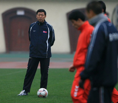 19일 오후 북한 축구국가대표팀 김정훈 감독이 중국 충칭 다티안완구장에서 열린 훈련에서 선수들을 지켜보고 있다. 