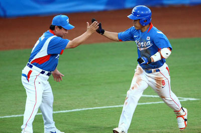 15일 베이징 우커송야구장에서 열린 베이징올림픽 야구 예선 한국-캐나다 전 3회초 2사, 정근우가 솔로 홈런을 날린 뒤 김광림 코치와 하이파이브를 하고 있다. 