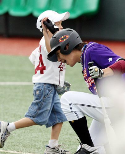  25일 광주 무등야구장에서 열린 2009 프로야구 올스타전에 앞서 KBS 인기 프로그램 ‘천하무적 야구단’ 출연진과 올스타 선수들이 참가하는 ‘천하무적 야구 이벤트’ 중,  천하무적팀 김준이 올스타팀 브룸바(히어로즈)의 아들과 하이파이브를 하고 있다. 