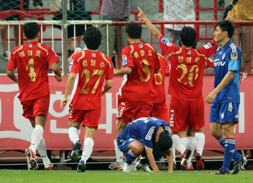 15일 부산 아시아드주경기장에서 열린 프로축구 K리그 부산 아이파크 대 수원 삼성의 경기. 후반 부산 양동현이 헤딩슛을 성공시킨 뒤 동료들과 기뻐하는 가운데 수원 수비수 문민귀가 고개를 숙인 채 잔디에 엎드려 있다. 