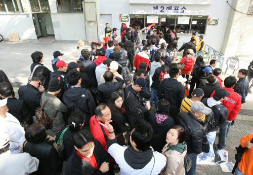 22일 오후 잠실야구장에서 야구팬들이 한국시리즈 5차전 기아-SK 경기의 입장권을 구하기 위해 길게 줄을 서고 있다. 